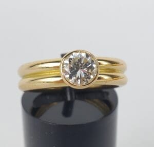 Gold ring with large round diamond solitaire.