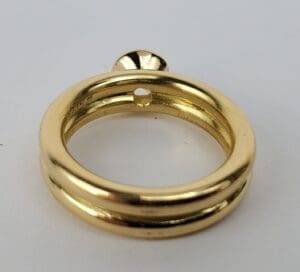 Gold ring with a small round decoration.