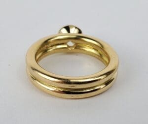 Gold ring with a small round accent.