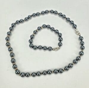 Necklace and bracelet with dark beads.