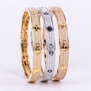 Three luxury bracelets in gold, silver.