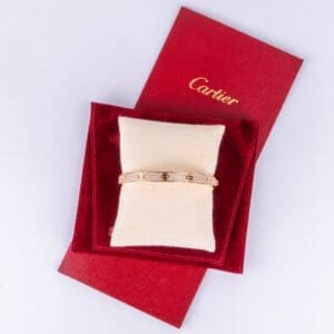 Cartier bracelet on red velvet pouch.