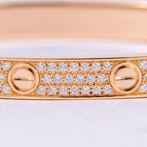 Gold bracelet with diamonds and screw motifs.