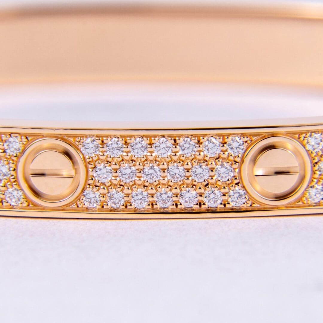 Gold bracelet with diamonds and screw motifs.