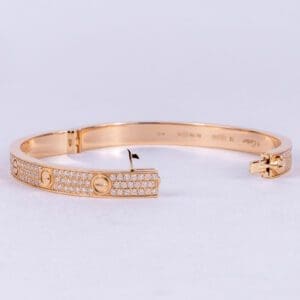 Gold bracelet with diamond accents, open clasp.