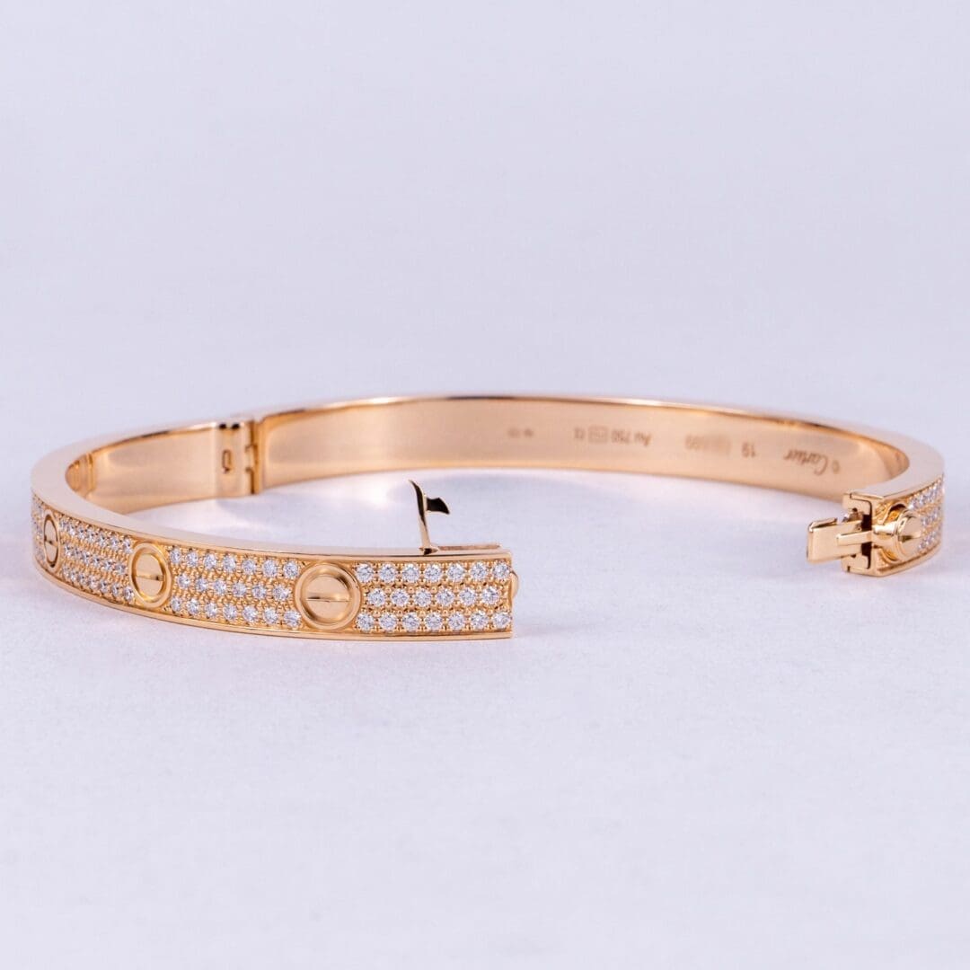 Gold bracelet with diamond accents, open clasp.