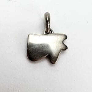 Silver tooth-shaped pendant on white background.
