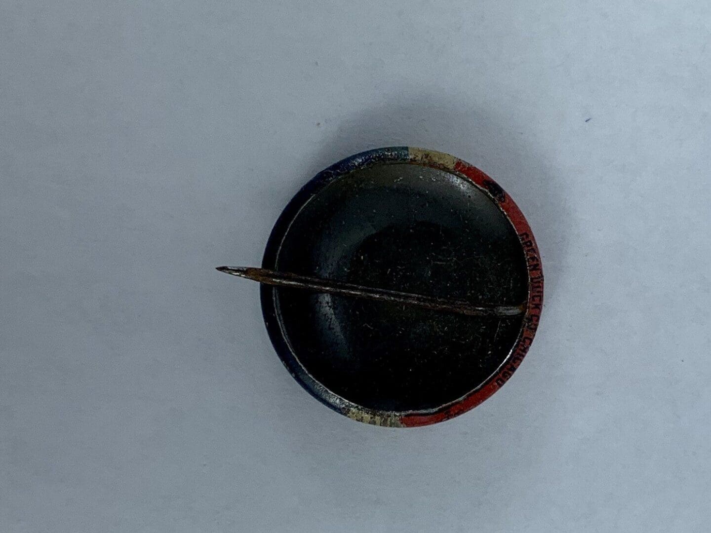 Round object with a stick across it.