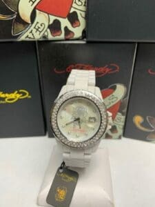 White watch with jeweled bezel display.