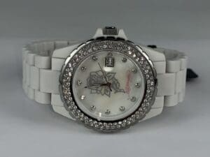 White watch with diamond-encrusted bezel.