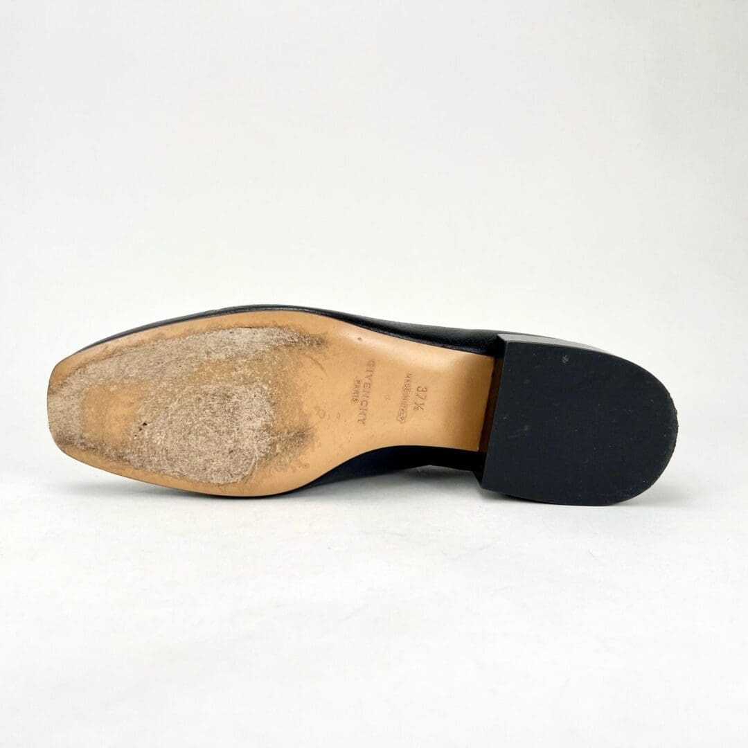 Worn sole of a men's dress shoe.