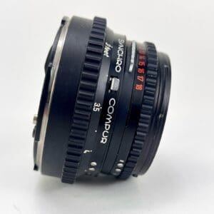 Black Synchro Compur camera lens, side view.