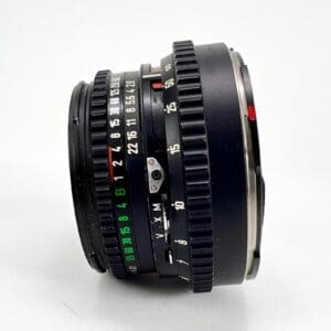 Vintage camera lens with focus and aperture rings.