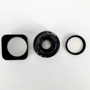 Camera lens with hood and filter.