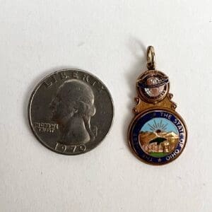 Quarter coin and Ohio state pendant.