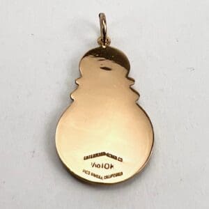 Gold snowman-shaped pendant with engraved text.
