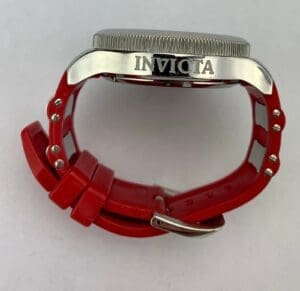 Red-banded watch with "Invicta" engraved on side.
