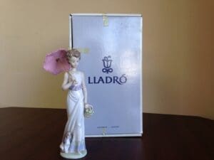 Porcelain figurine with box, pink umbrella.