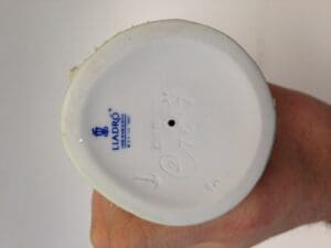Lladro figurine base with logo stamp.