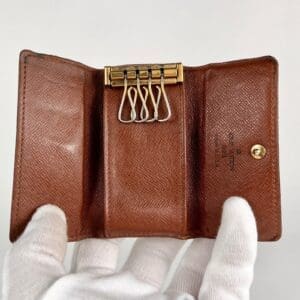 Brown leather key holder with metal hooks.