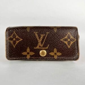 Brown patterned designer wallet with button closure.