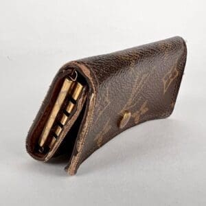 Brown leather key holder with snap button.