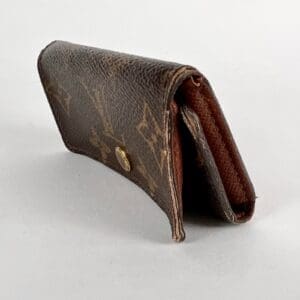 Brown leather wallet with gold button.