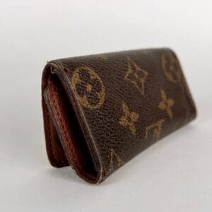 Brown patterned wallet on light background.