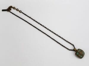 Antique necklace with green pendant.
