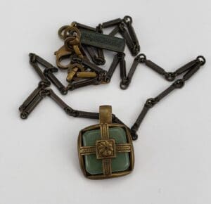 Vintage bronze necklace with square green pendant.