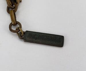 Bronze chain with Jan Michaels tag.