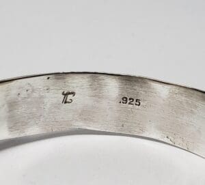 Silver ring with '.925' engraved marking.