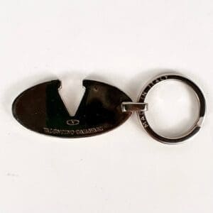 Metal keychain featuring an oval design.