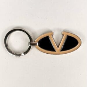 Keychain with oval emblem and letter V.