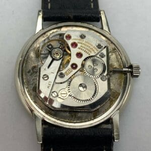 Watch movement with exposed mechanical components.