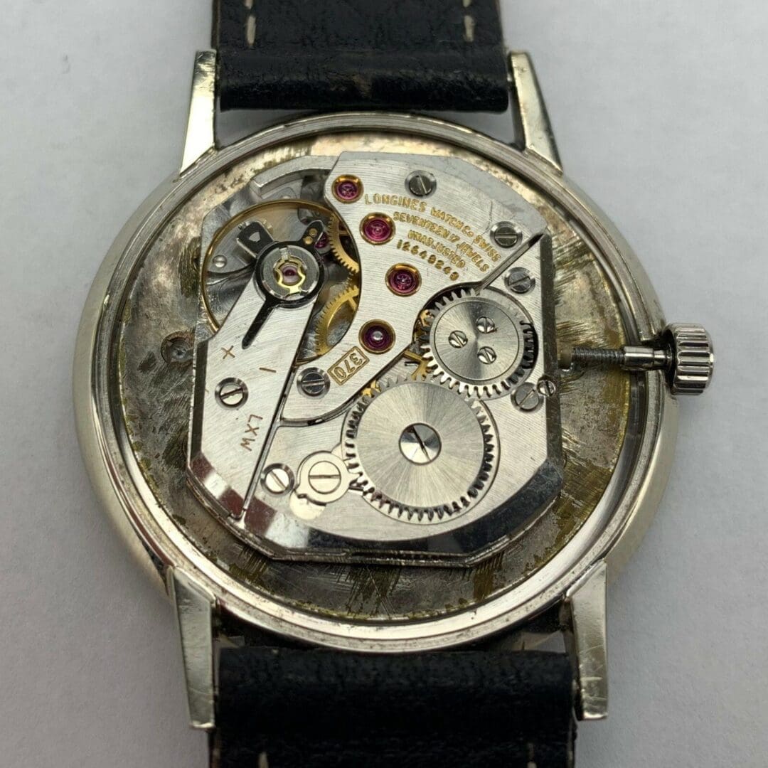 Watch movement with exposed mechanical components.