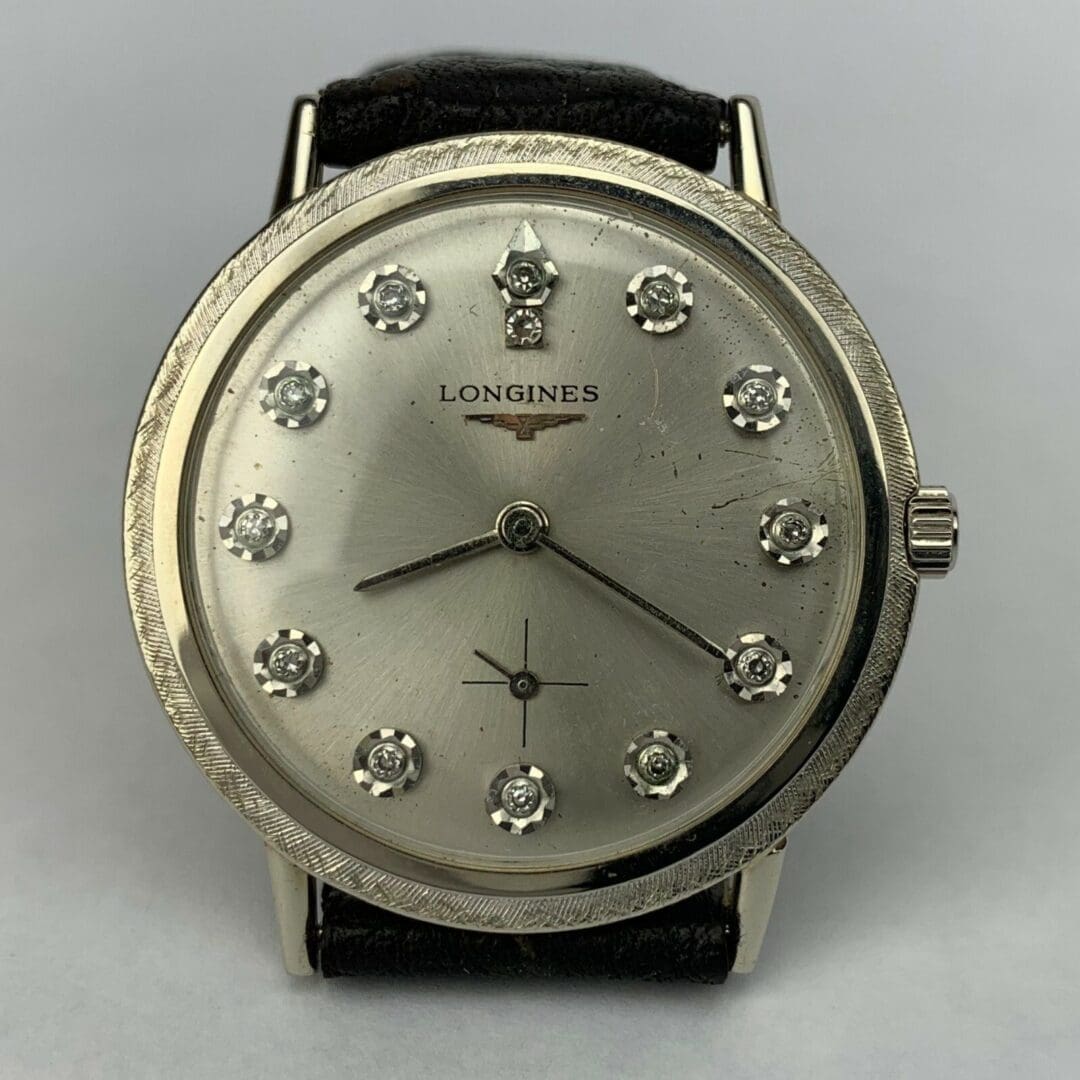 Silver wristwatch with diamond hour markers.