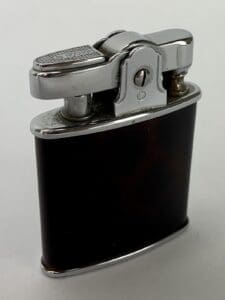 Vintage metal and black cigarette lighter.