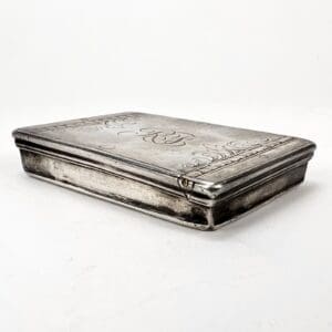 Engraved silver box with intricate details.
