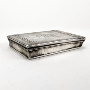 Rectangular silver box with engraved design.