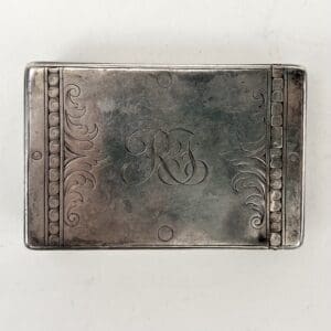 Engraved silver box with decorative patterns.