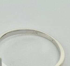 10K gold ring on white background.