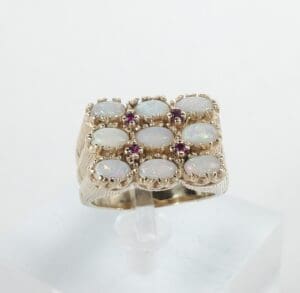 Gold ring with opals and purple stones.