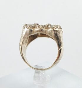Gold ring with intricate raised design.