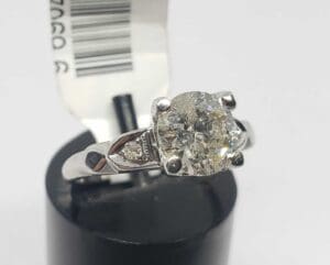 Silver ring with a large diamond.
