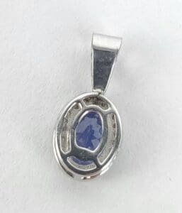 Silver pendant with blue oval gemstone.