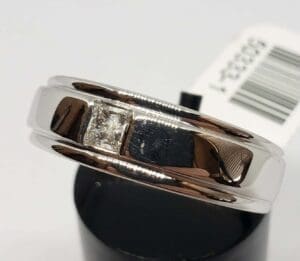 Silver ring with a square diamond.