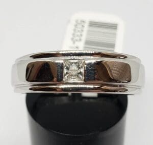 Silver ring with a square diamond center.