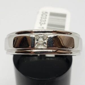 Silver ring with a square diamond center.