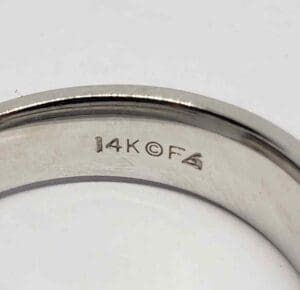 14K gold ring with engraved markings.